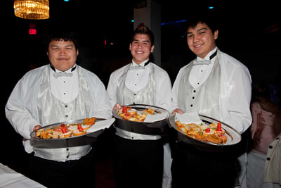 Waiters with serving trays at a corporate event