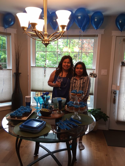 Blue table settings and two guests at a private party